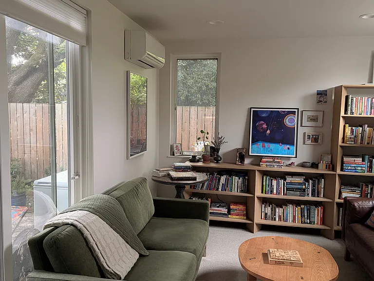 Living room with sliding glass door that opens onto the patio and backyard