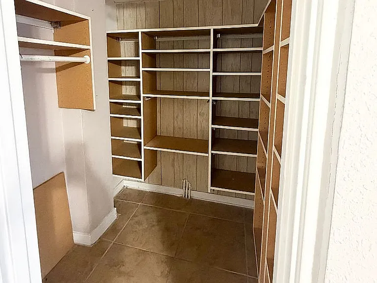 Spacious walk-in closet with modern shelving and ample storage solutions.