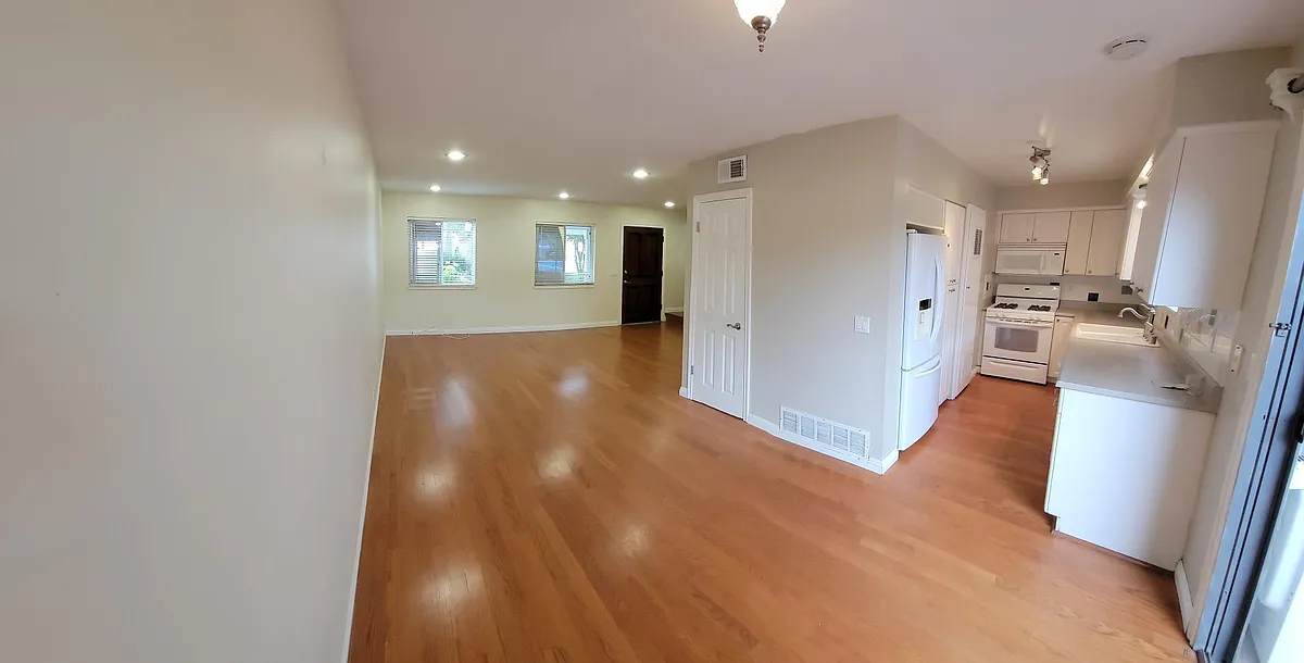 View of the front entry, open family room area, dining area, and kitchen. - 19802 Margate Ln