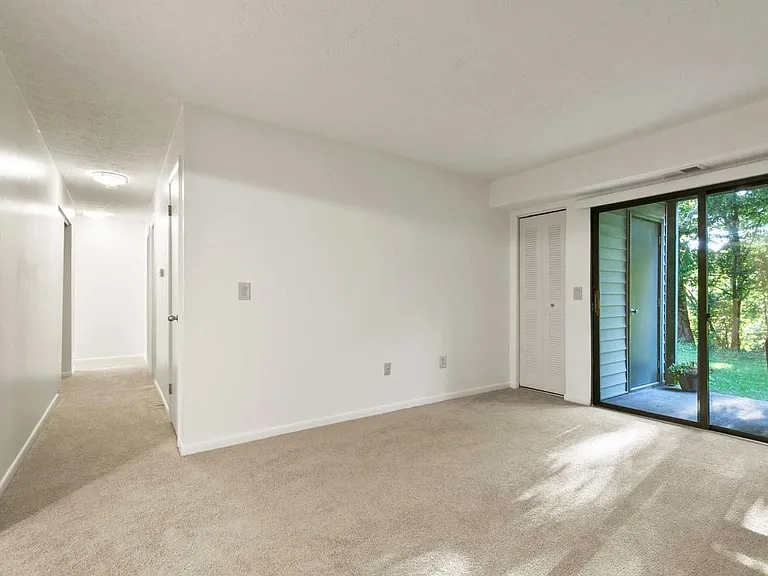 Spacious Living Room with Sliding Glass Doors Leading to Private Patio