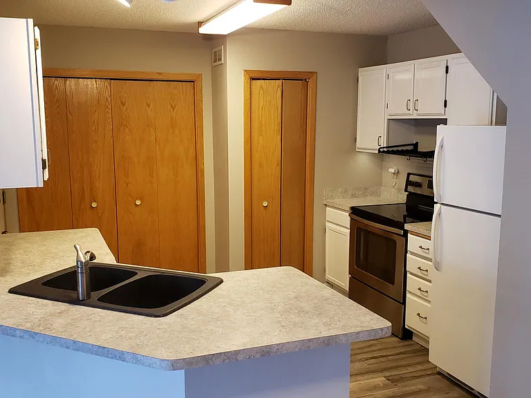 Smooth top range. Shelf available for microwave oven. Washer and dryer behind large closet plus storage.