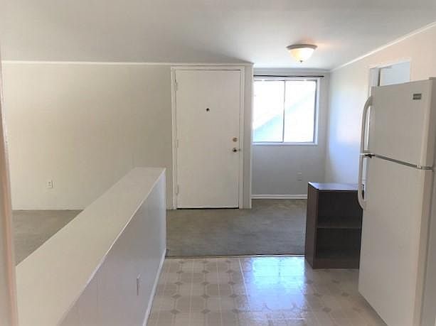 Looking at entry from kitchen. Living room to left and den plus deck to right.
