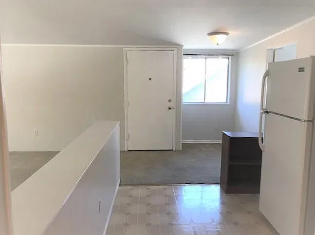 Looking at entry from kitchen. Living room to left and den plus deck to right.