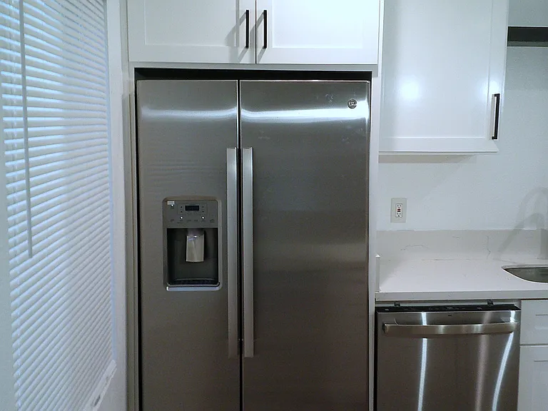 New stainless steel double door refrigerator and dishwasher.