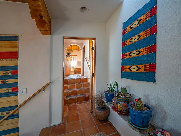 Southwest accents grace split level stairways. Saltillo tiles throughout.