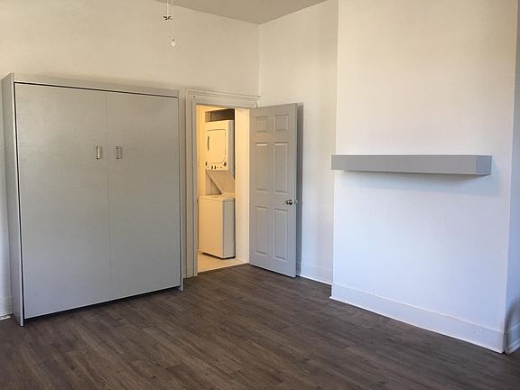 View to bathroom door and washer dryer.