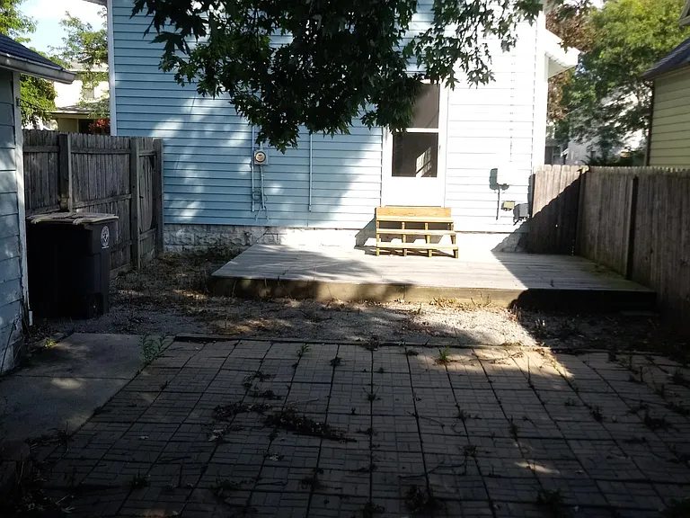 Your backyard has a deck, is tree-covered, and is completely fenced in!