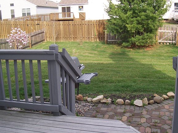 Fenced in back yard with deck and patio