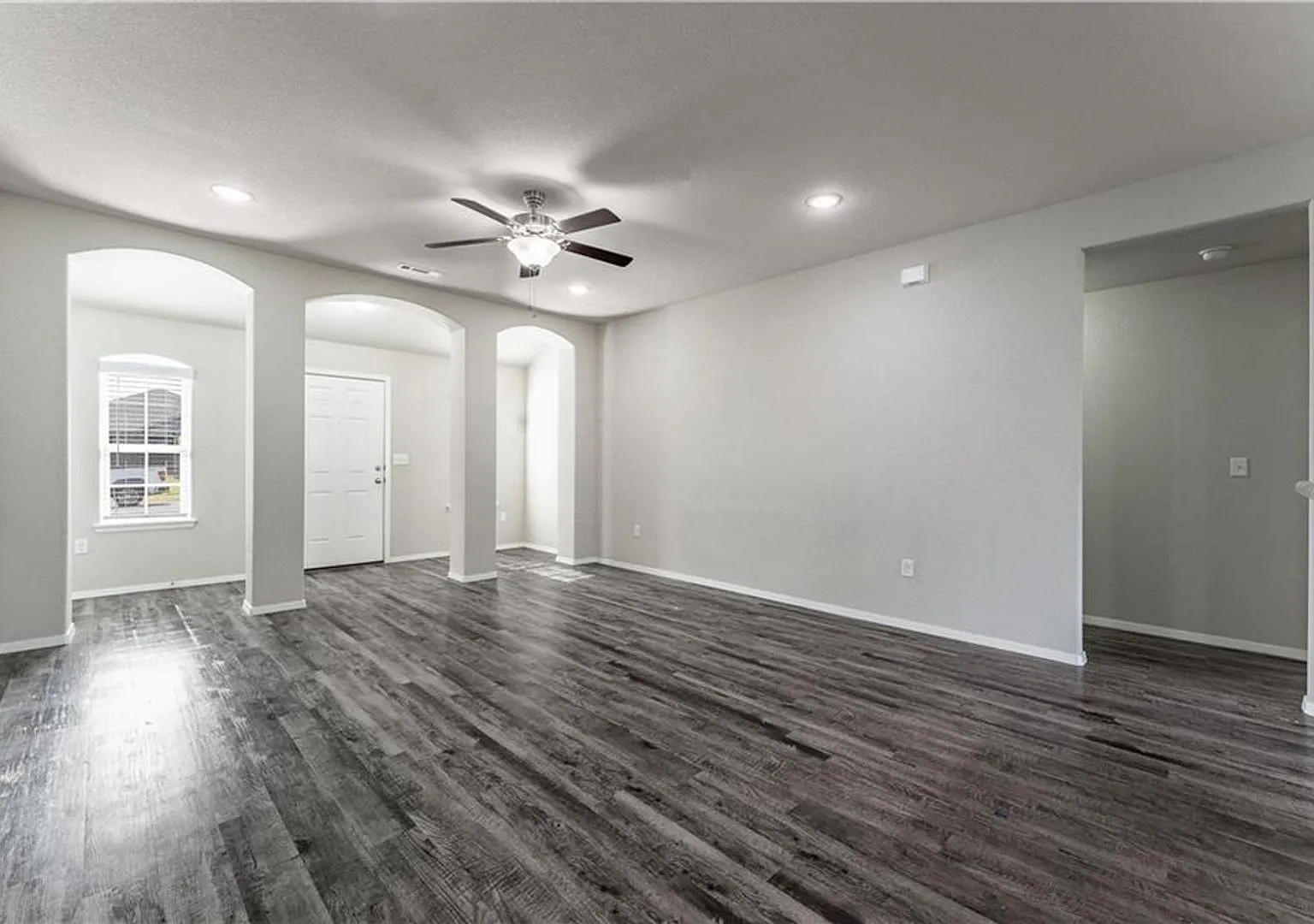 Home is very open, bright with 3 grand arch ways and plank wood flooring — Photo 4