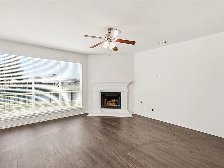 The living room. Large windows looking out onto the waterway at the back. Luxury vinly bank floor recently installed. And cozy gas fireplace too.