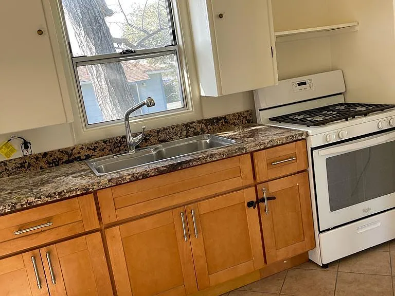 Kitchen with granite countertop and gas stove
