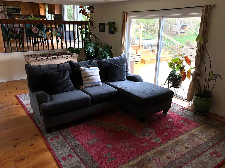 Sunken living room with foozeball table, couch and big sliders out to new deck