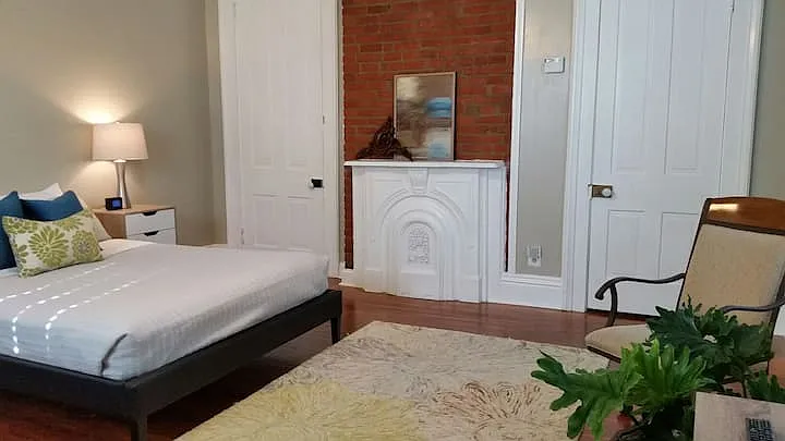 Large studio bedroom off of kitchen/entry, ceiling fan, lots of windows and floors have been refinished since this photo.