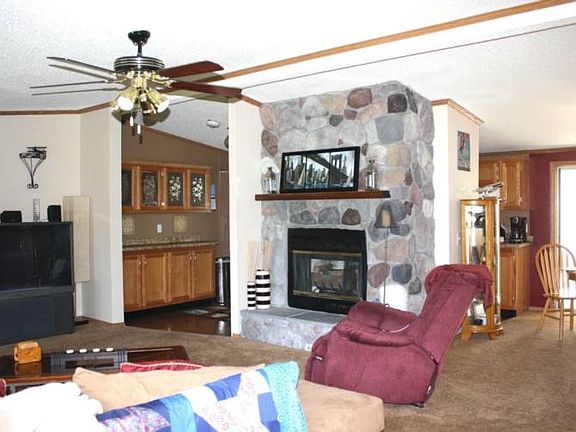Walking in the front door, this is what you see! Cozy gas log stone fireplace and an open layout with vaulted ceilings throughout. 