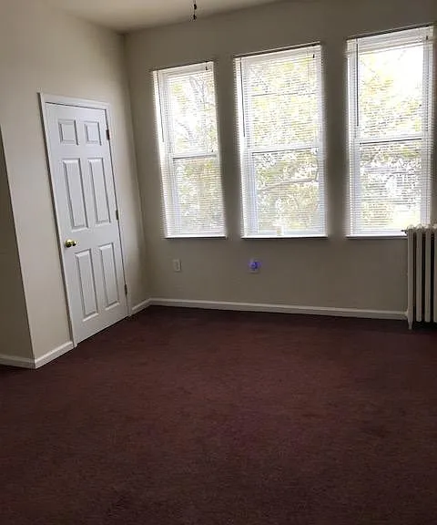 One large bedroom with lots of light.