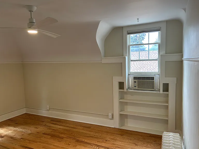 Living room with north facing window. Ceiling is 8' with angled walls