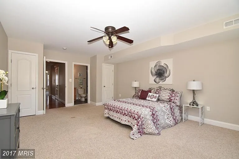 Bedroom 1 features two closets and is shown with a king size bed! It now has hardwood floors, too!