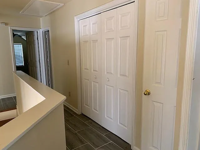 Upstairs hallway with laundry closet and linen closet
