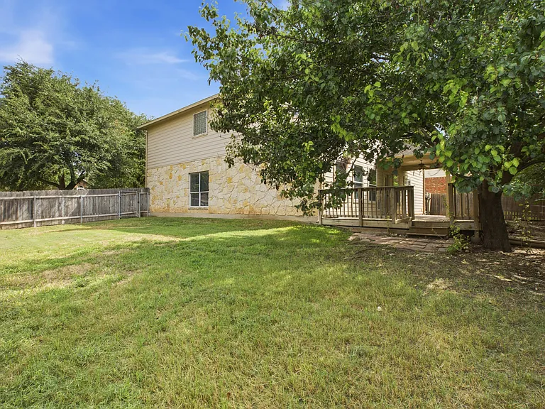 Large wooden deck, covered patio and large grassy section