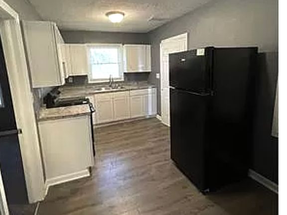 Modern kitchen includes stackable washer and dryer