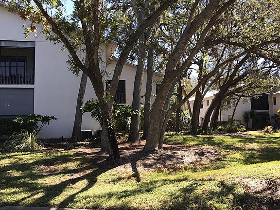 Exterior view of condo at upper right. Tennis court is acros