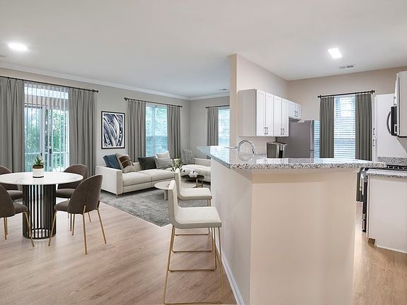 Renovated Package II kitchen and living room with hard surface flooring