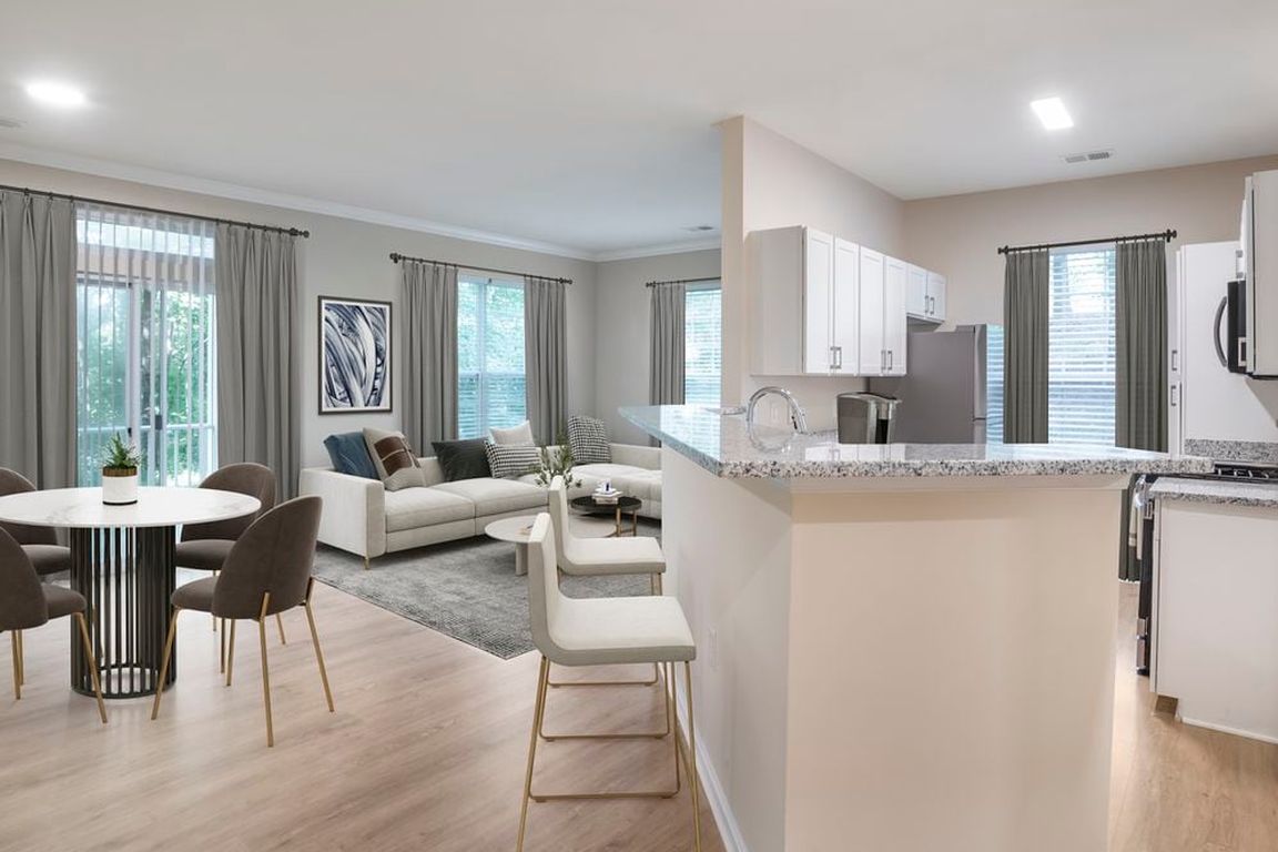 Renovated Package II kitchen and living room with hard surface flooring