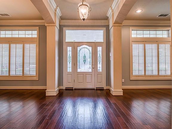 Grand entry with formal living to the right and formal dining to the left with entry to butlers' pantry.