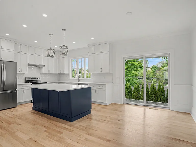 Expansive Glass Sliders Lead to the Patio, Offering an Effortless Transition to Outdoor Dining and Entertaining.