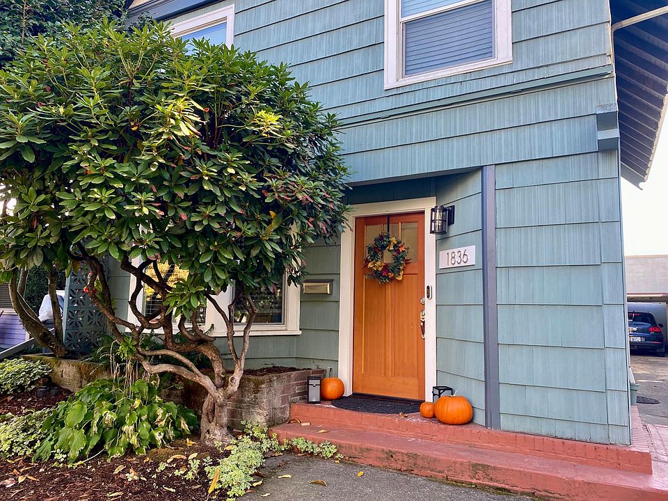 Front entrance to two-unit home featuring off street parking and fenced backyard.