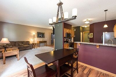 Open dining room with breakfast bar and patio door to backyard.