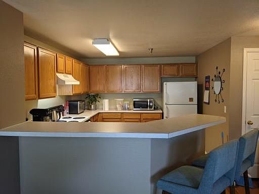 Kitchen with eating counter.