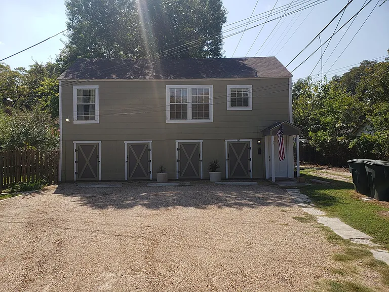 Storage units on 1st floor. 1 Bedroom/ 1 bathroom apartment on 2nd floor. Door to apartment on far right.