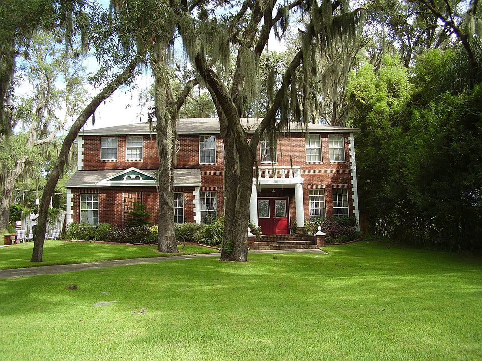 European style home on Lake Florence with pool in fenced in back yard.
