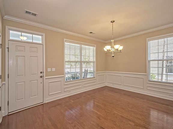 Transom above front door, gleaming wood flooring...