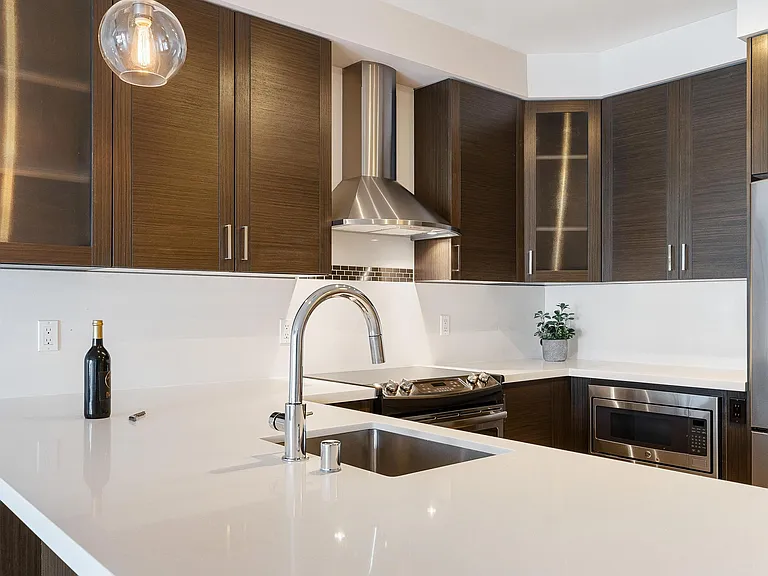 Kitchen offers Quartz countertops and espresso cabinetry.