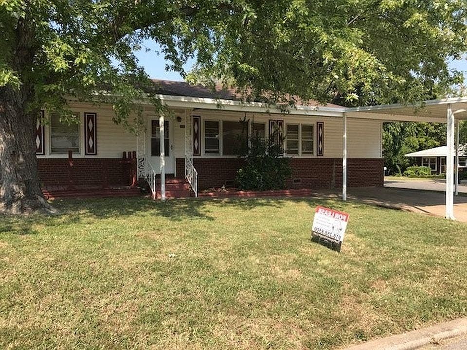 Front of home faces west, nice shade trees and carport