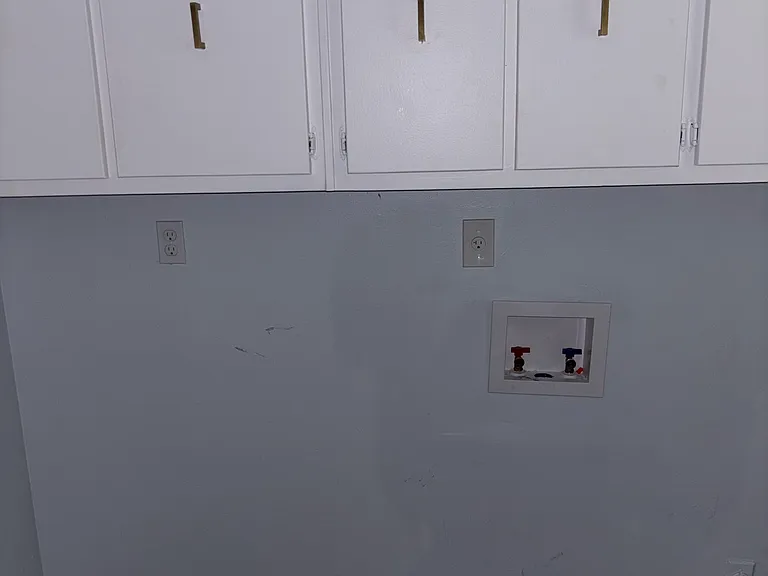 washer and dryer hookup and laundry storage space
