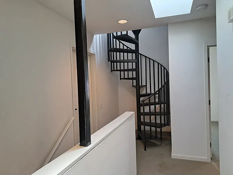Spiral Stairs to private rooftop deck - skylight above