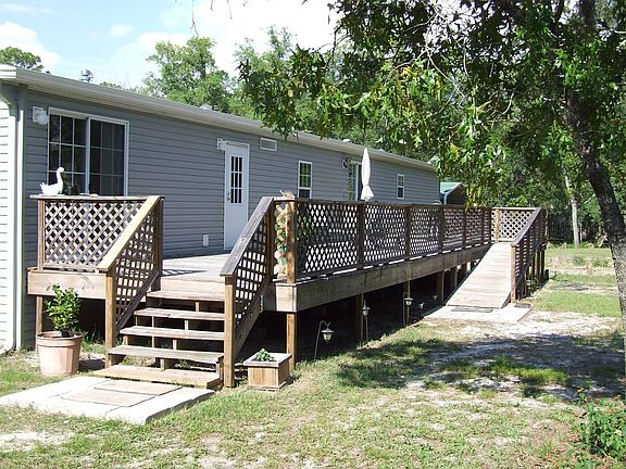 rear of home with deck and handicap ramp