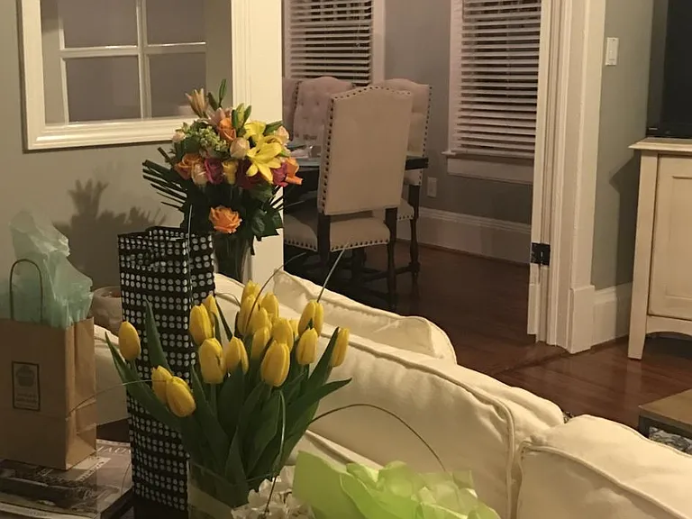 Living Room is separated from the dining room by oversized doorway and original French doors. Original architectural pass-through serving window for entertaining!