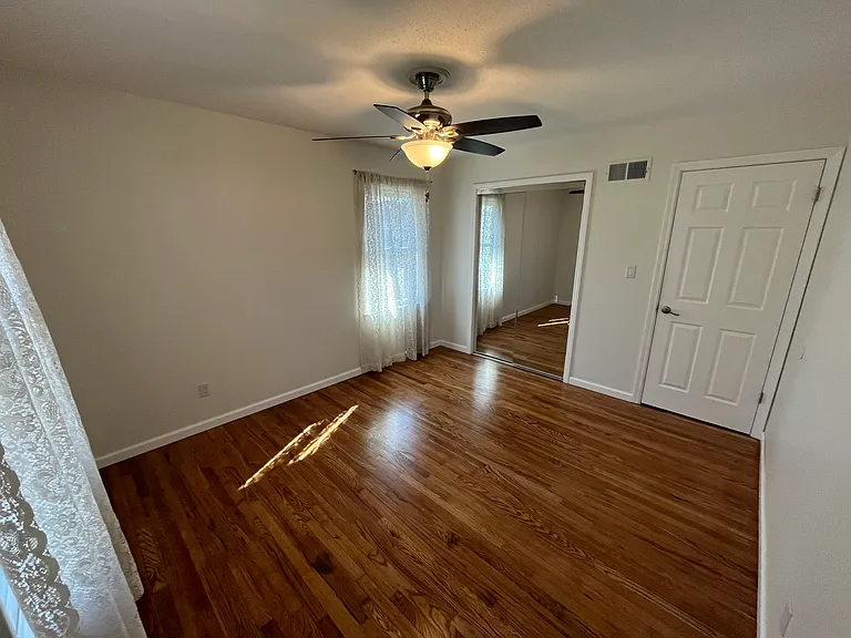 Mirror closets plus a NEW ceiling fan/light that matches 3 other rooms. Hardwood Oak is beautiful.