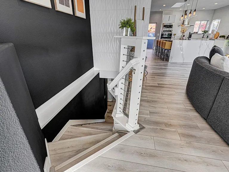 Stairs by the front door leading to the lower level