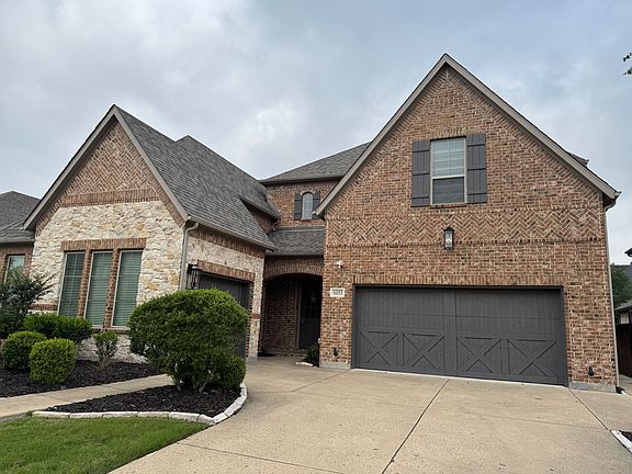 Front view with 3 car garages