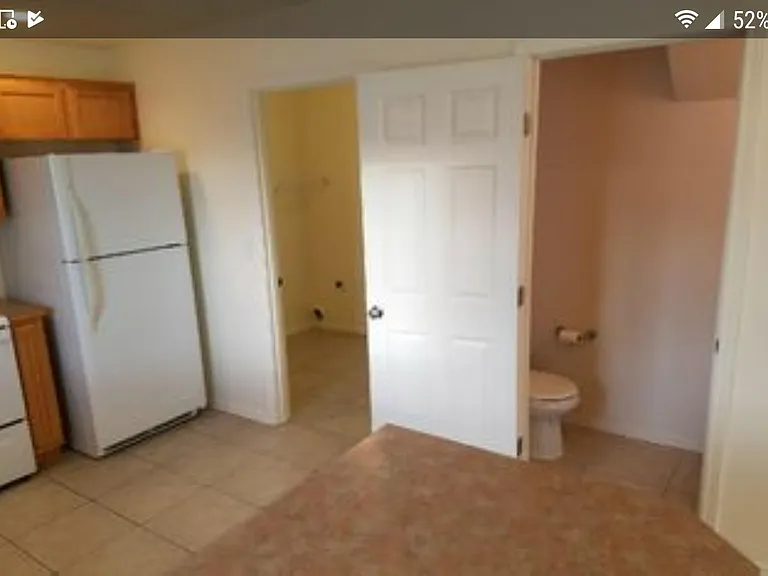 Large tile floored kitchen with utility laundry , room , washer and dryer and bathroom