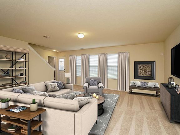 Inviting Family room with triple windows overlooks huge back yard. Virtually staged