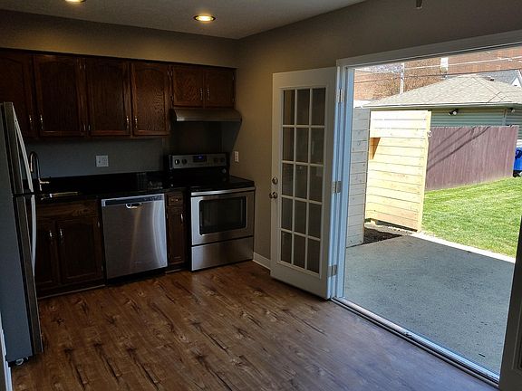 Kitchen with open french doors to large private backyard and patio!