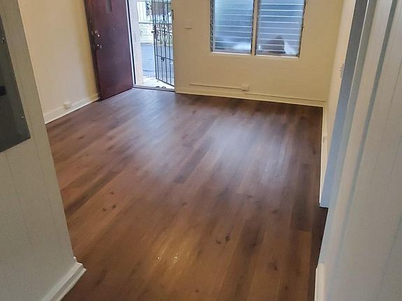 Looking into living room. New Floor, paint, fan and light.