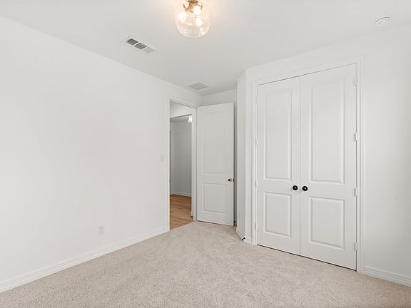 An additional view of the third bedroom and closet.