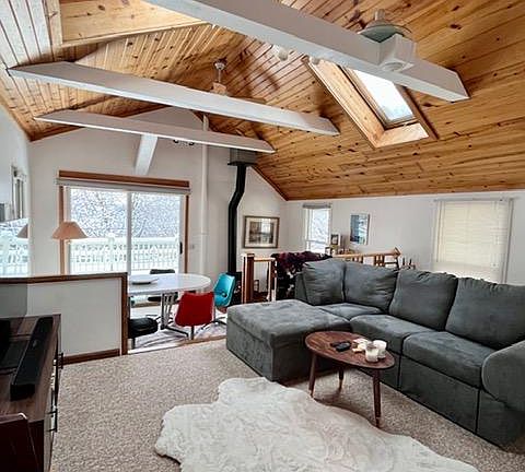 Wide open vaulted area, two levels 20 x 18, with free standing gas fireplace, skylights. Deck off back.